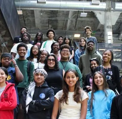 A group of students on the staircase of a modern building.