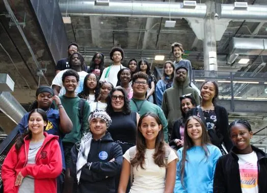 A group of students on the staircase of a modern building.